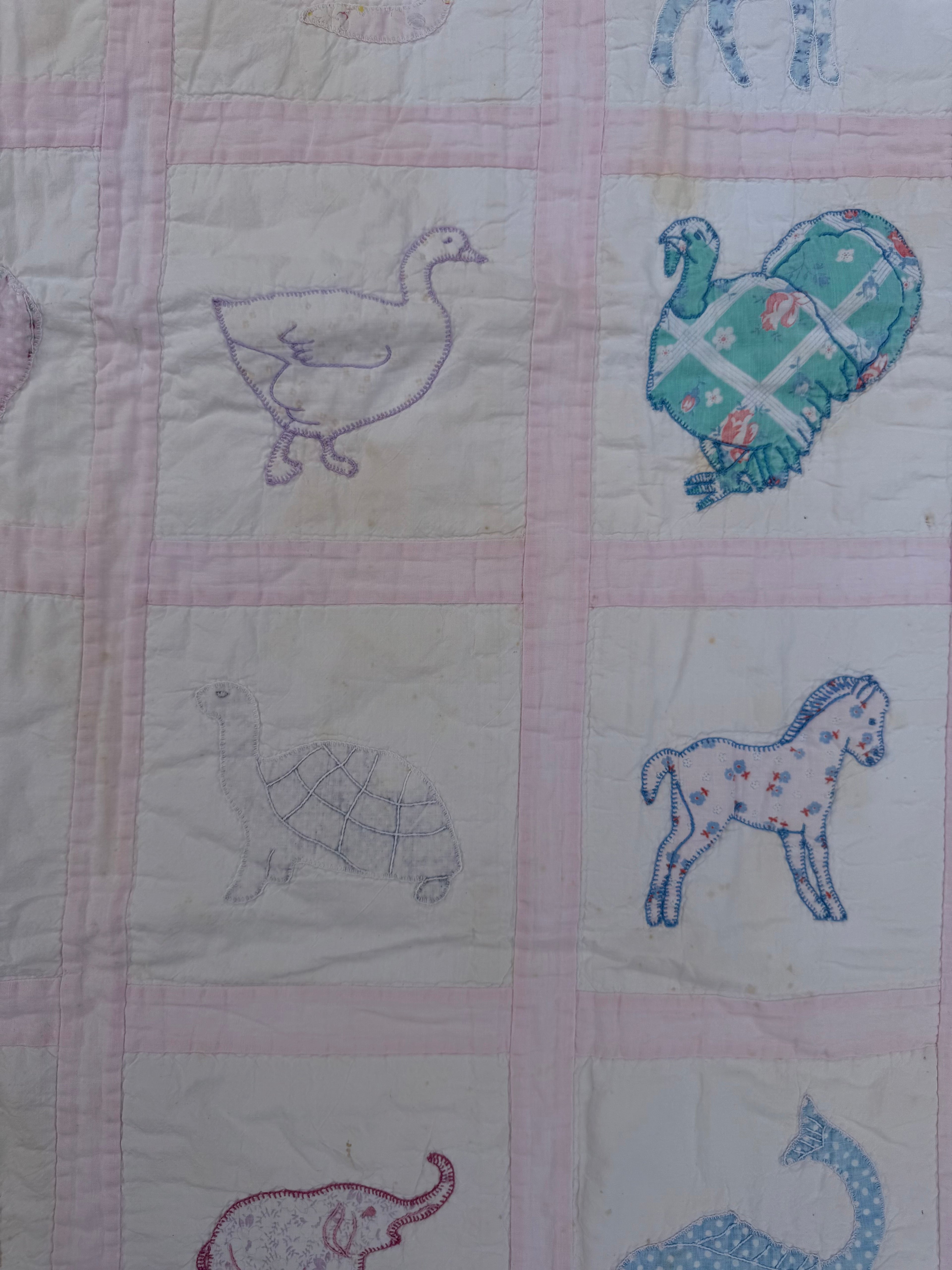 1940s appliqué animals of many fabrics crib quilt