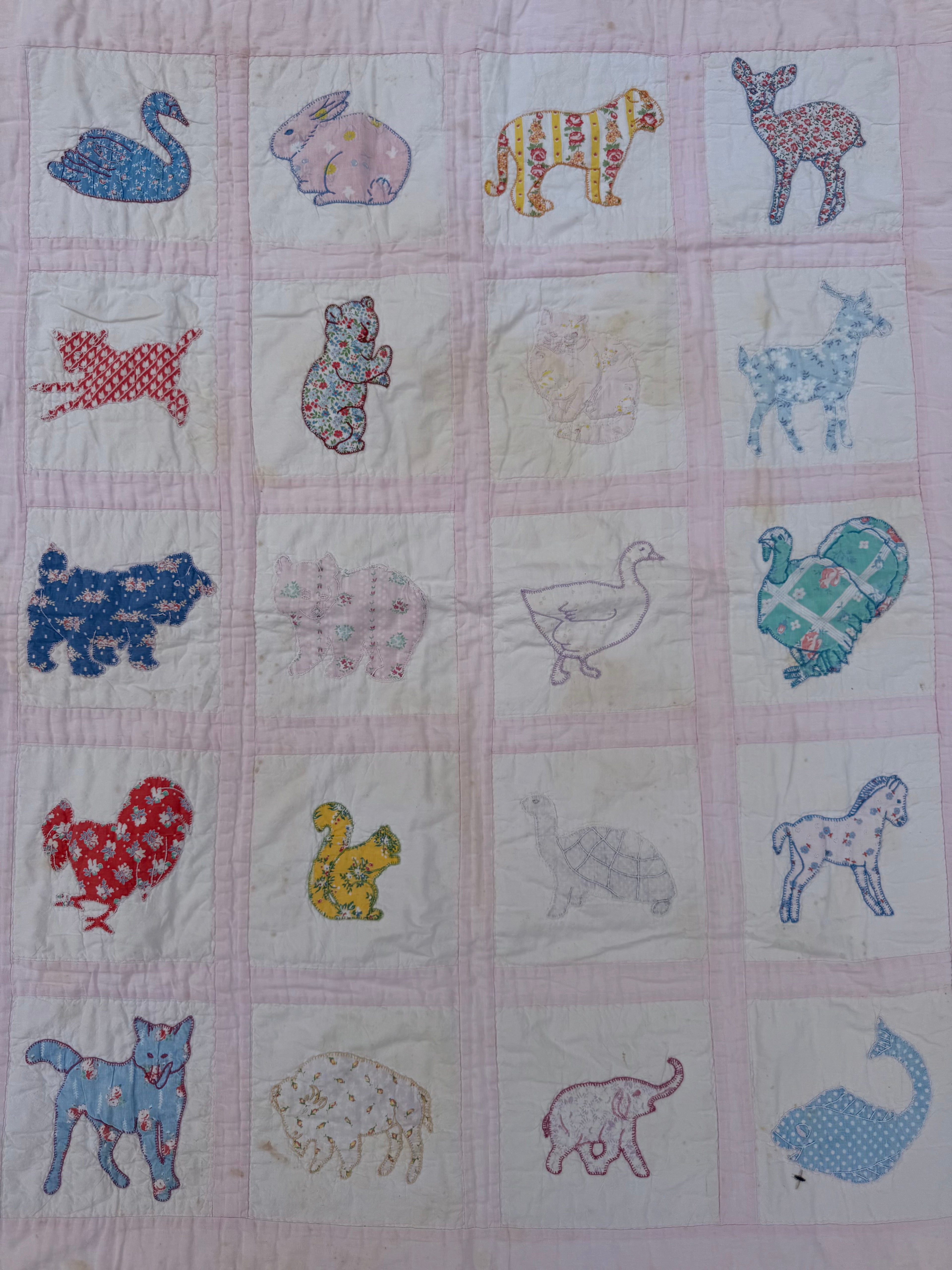 1940s appliqué animals of many fabrics crib quilt