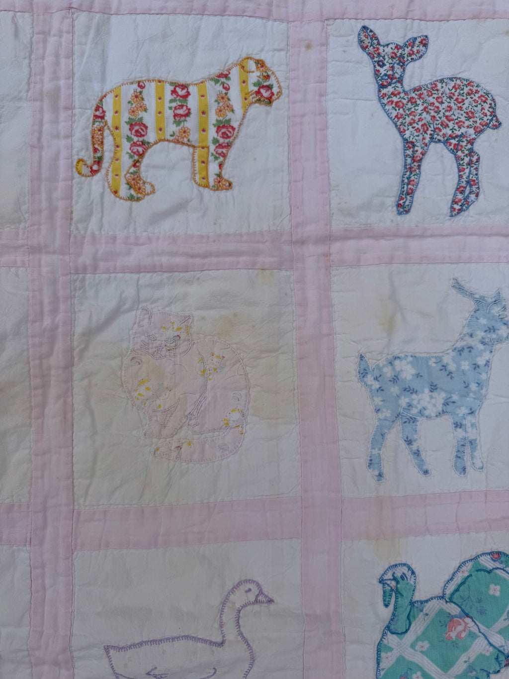 1940s appliqué animals of many fabrics crib quilt
