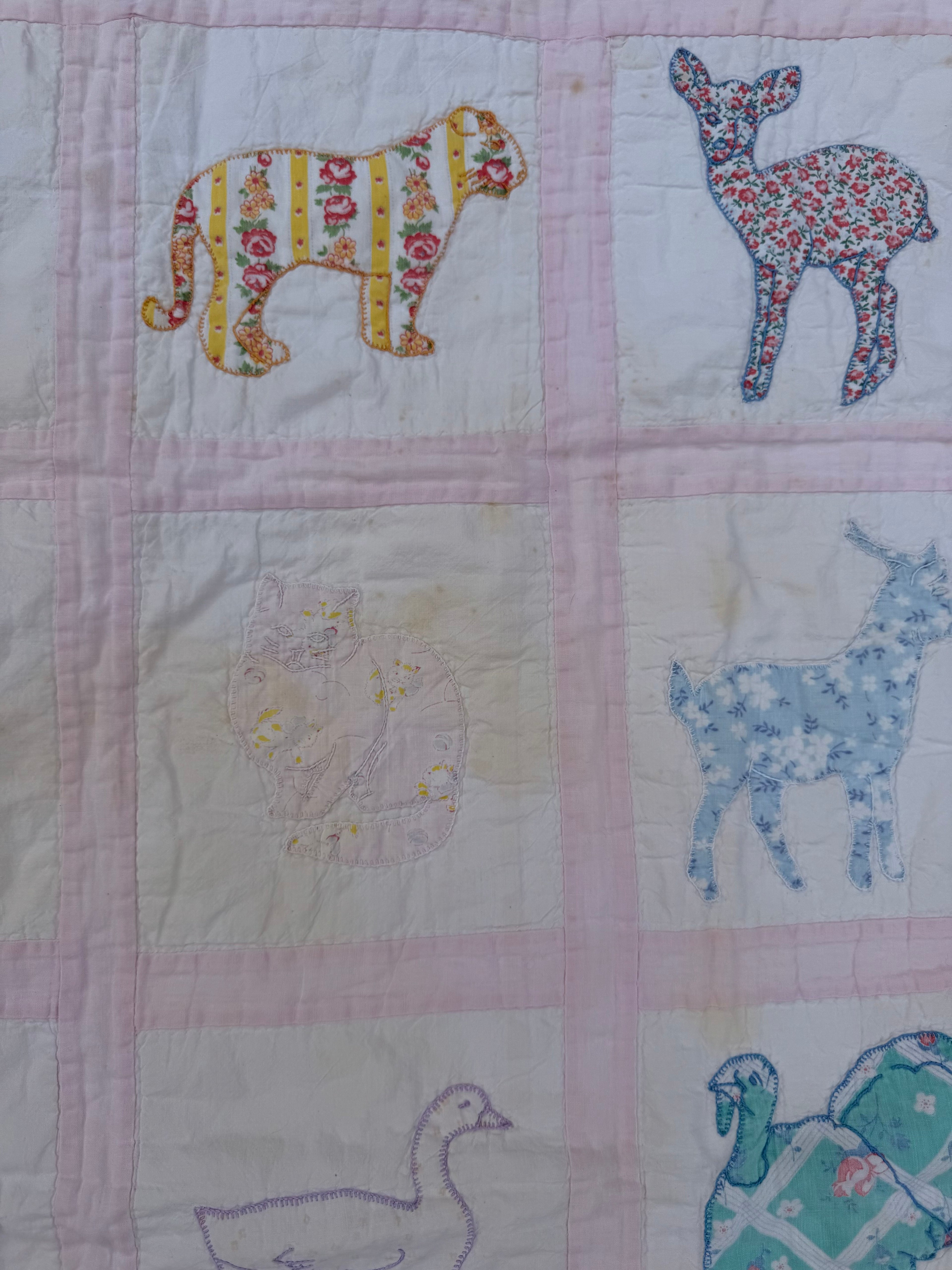 1940s appliqué animals of many fabrics crib quilt
