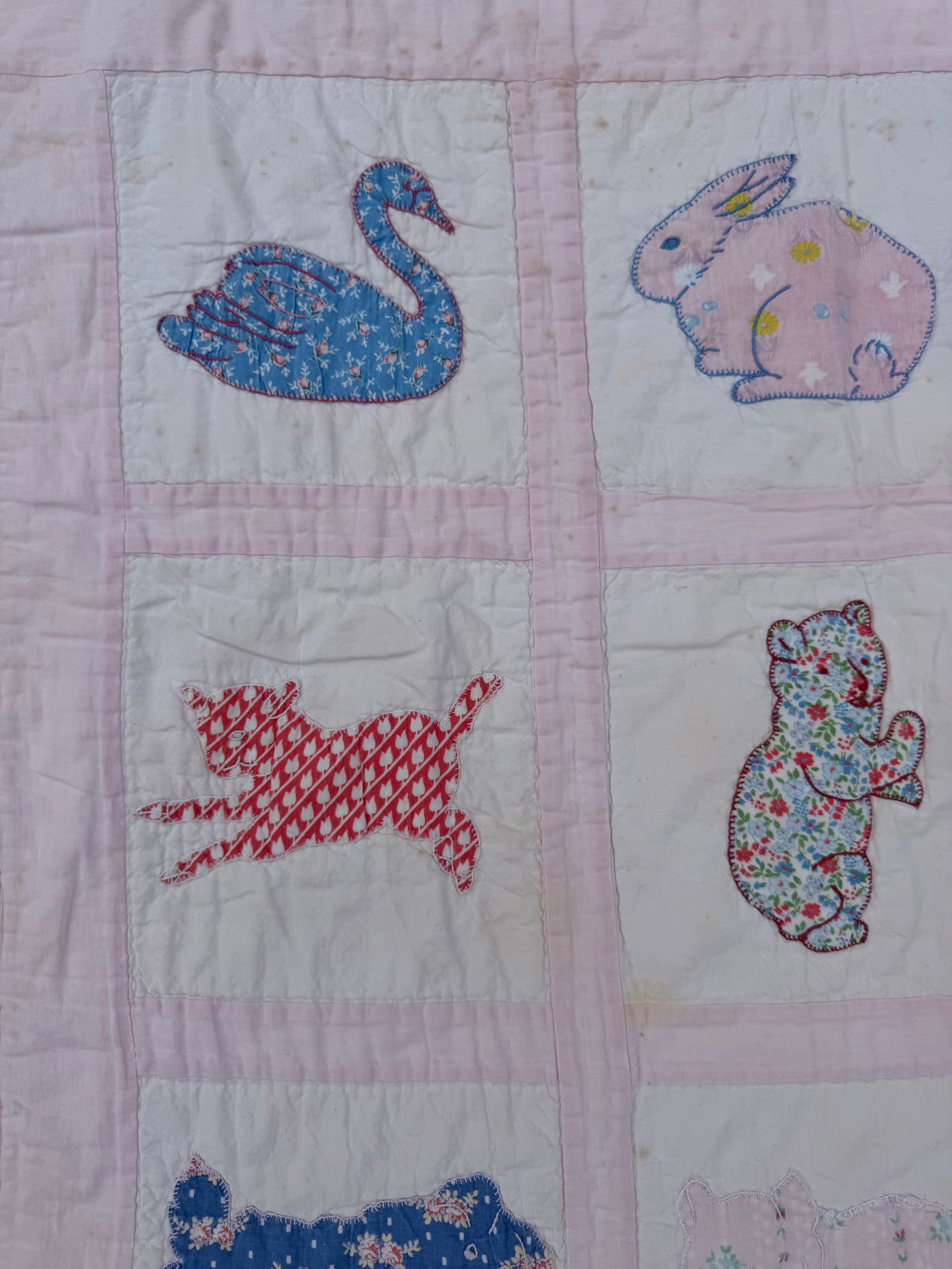 1940s appliqué animals of many fabrics crib quilt